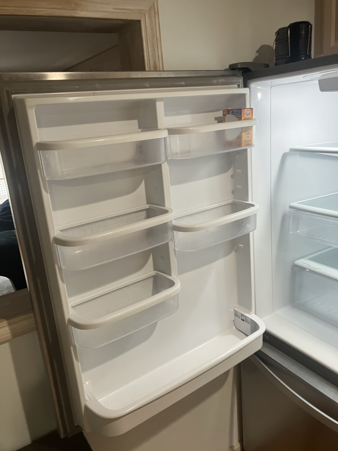 Refrigerator door and interior appearing generally clean at first glance